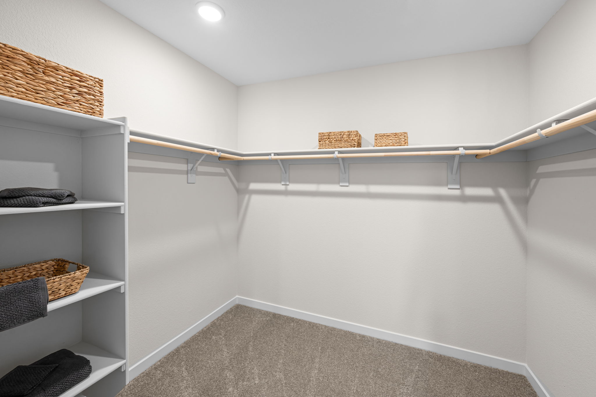 A white room with shelves and a white wall.