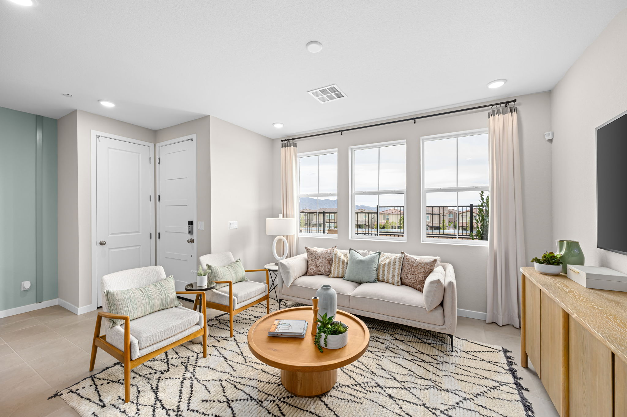 A living room with a couch and chairs.