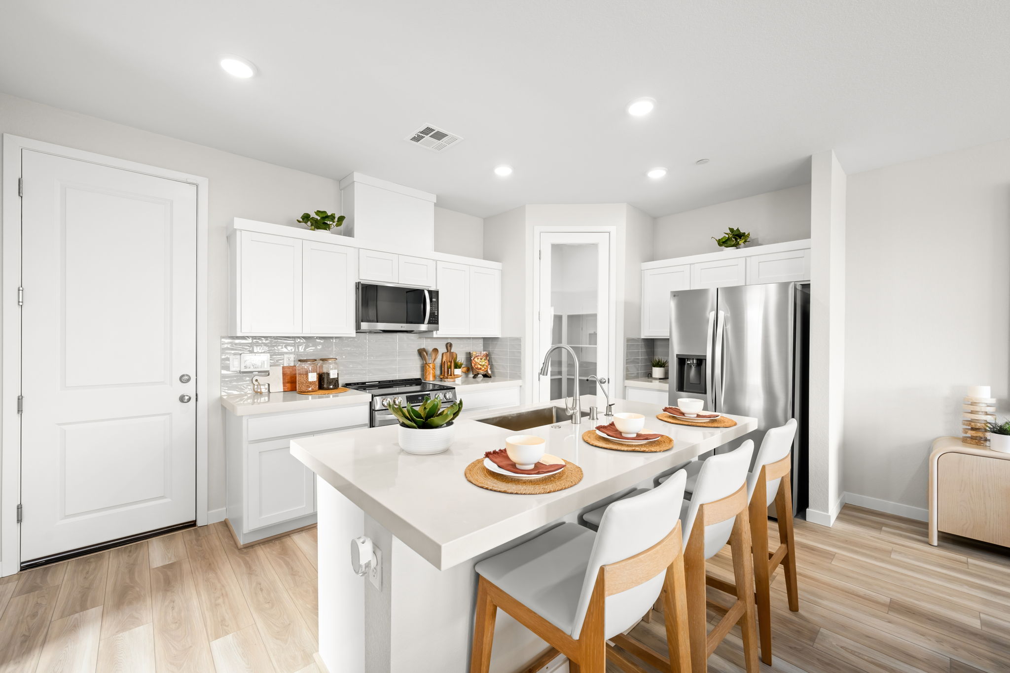 A kitchen with white cabinets.