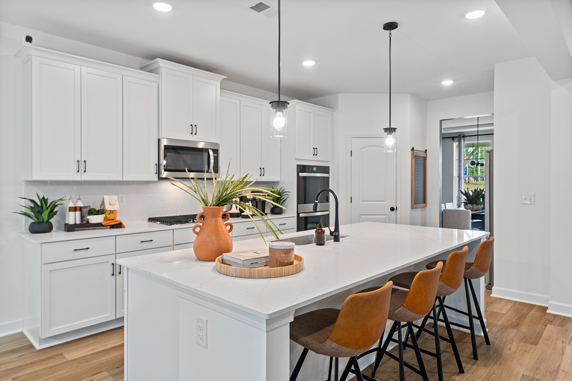 A kitchen with white cabinets.