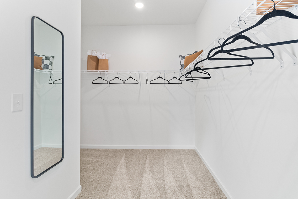 A room with a glass door and a mirror.