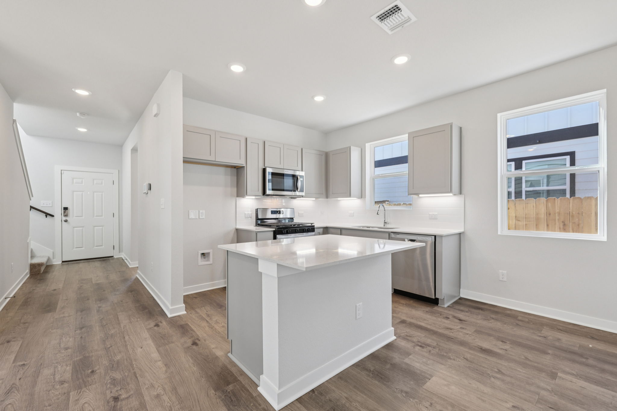 A kitchen with white cabinets.