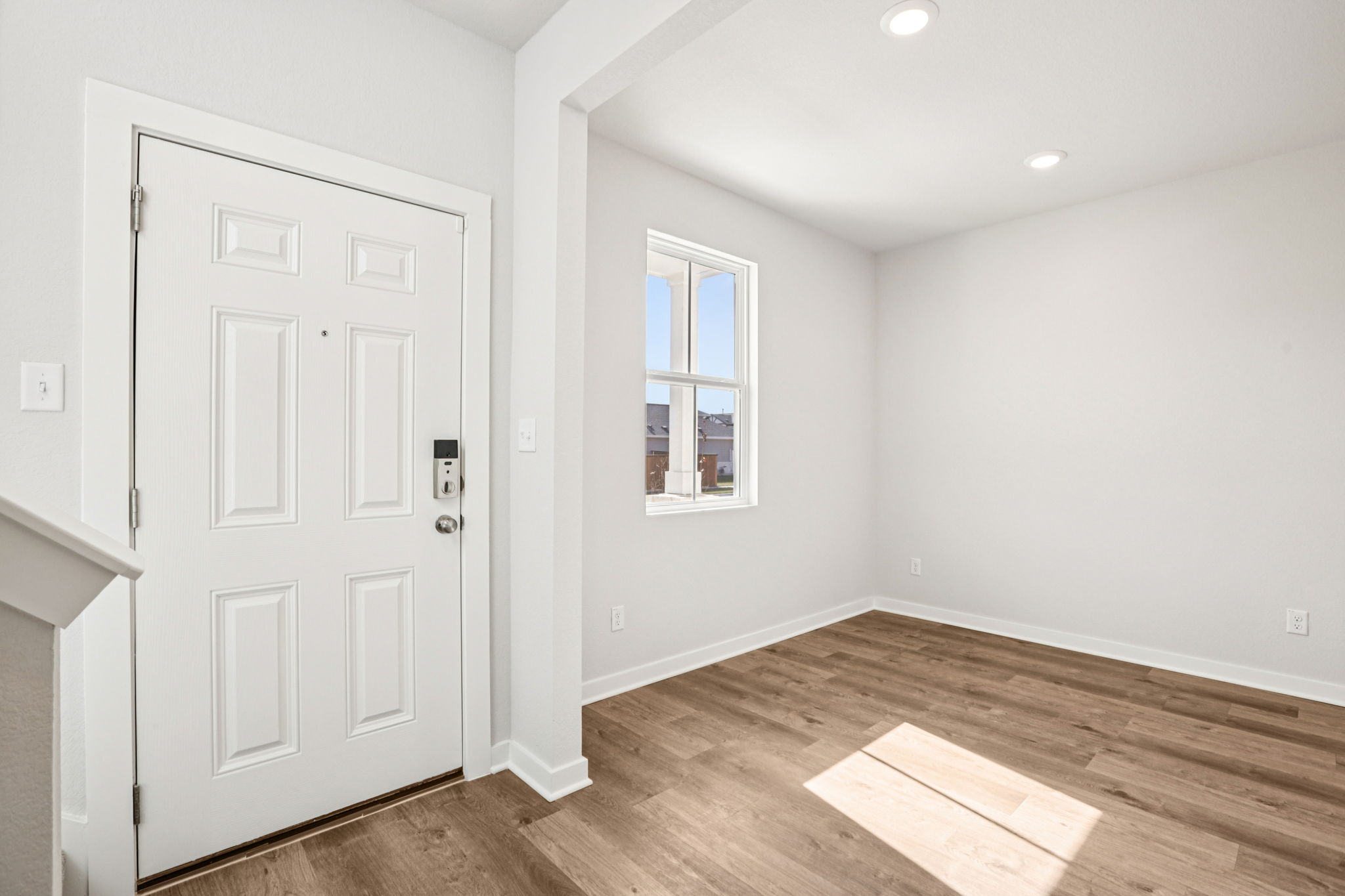 A room with white walls and a wood floor.