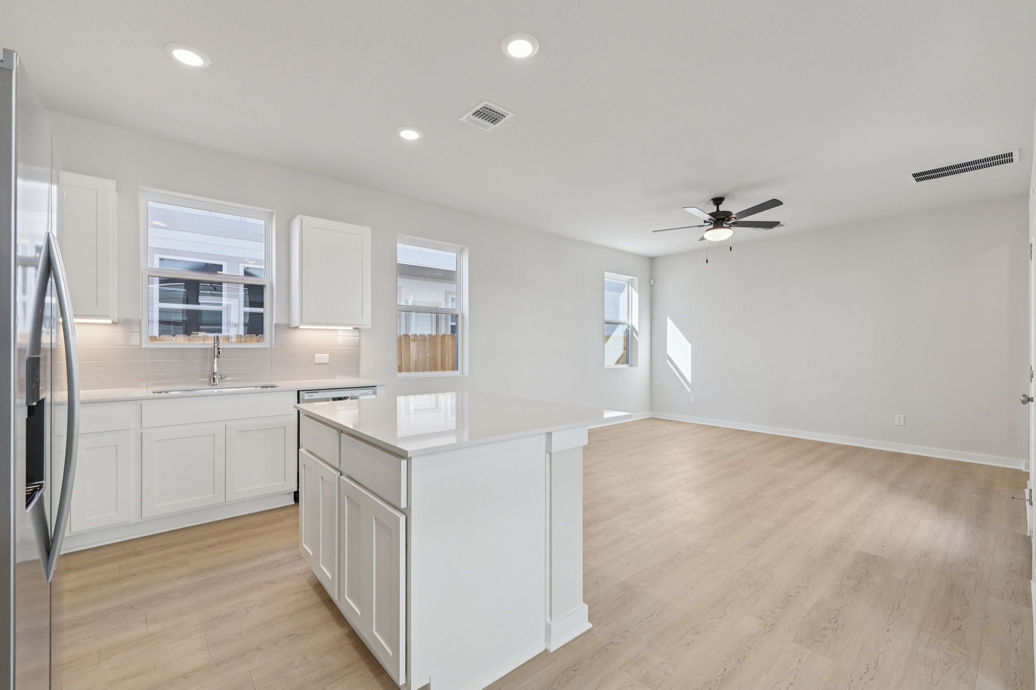 A kitchen with white cabinets.