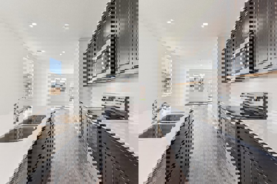 A kitchen with black cabinets.