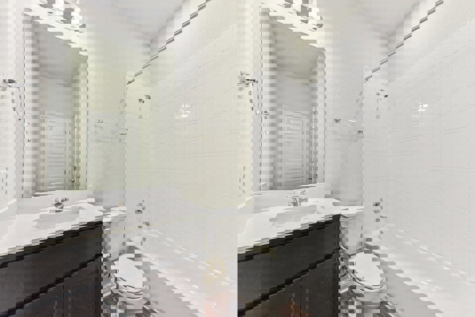 A bathroom with a tub toilet and sink.