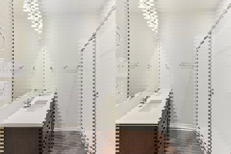 A bathroom with a sink and shower.