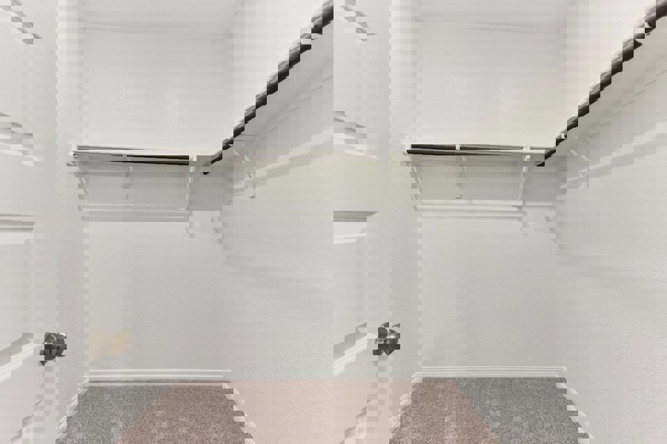 A shower with a metal bar.