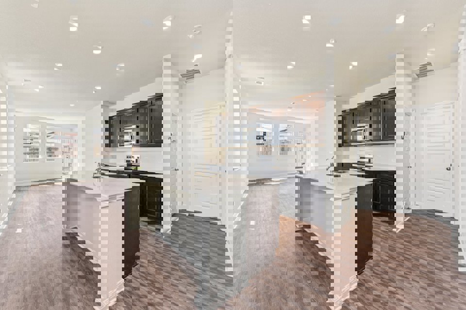 A kitchen with black cabinets.