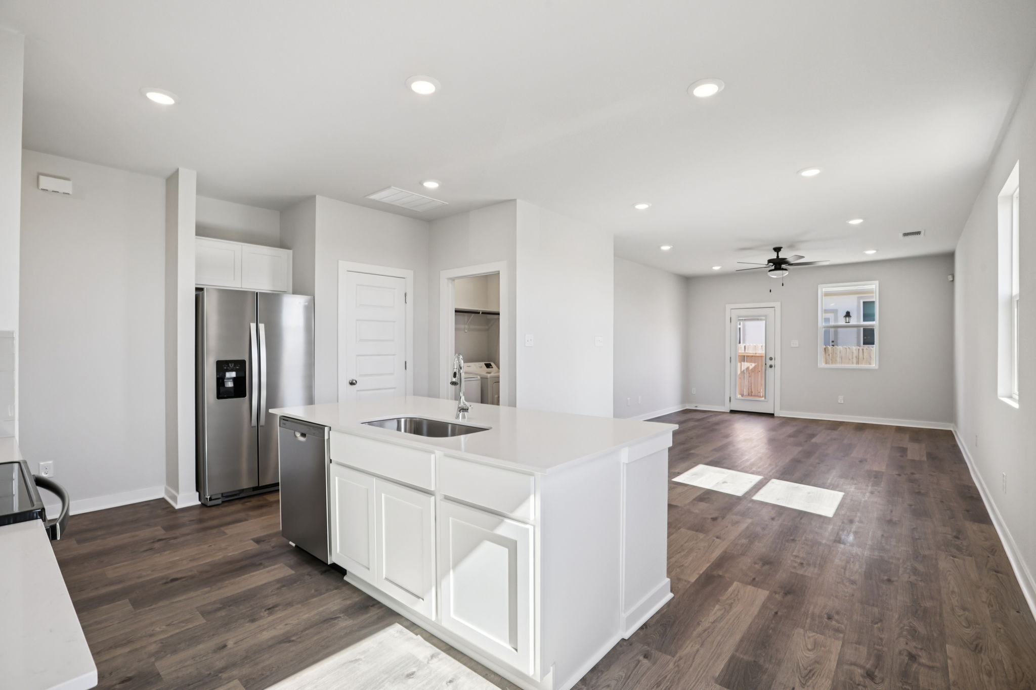 A kitchen with white cabinets.
