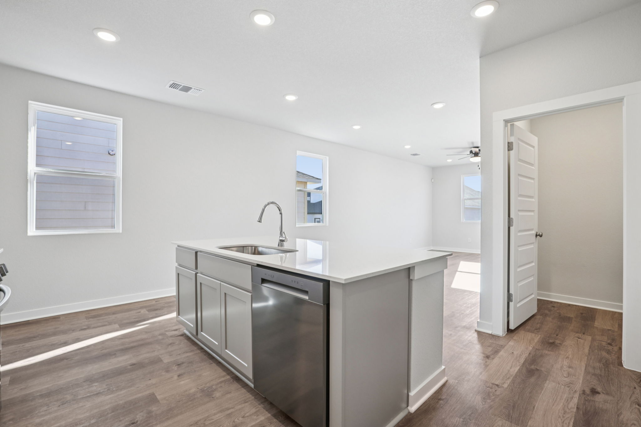 A kitchen with white cabinets.