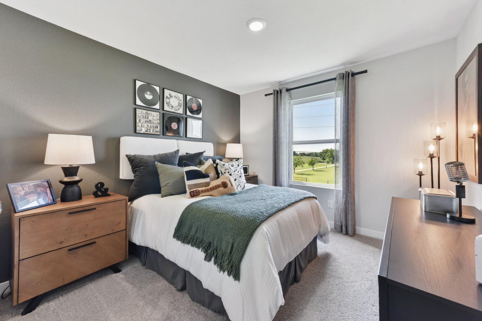 A bedroom with a large window.