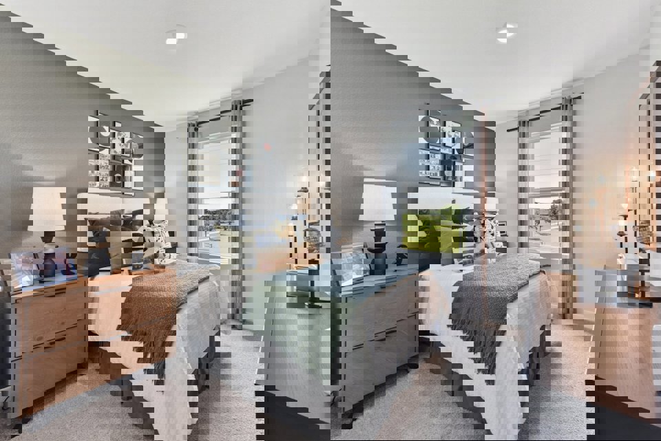 A bedroom with a large window.