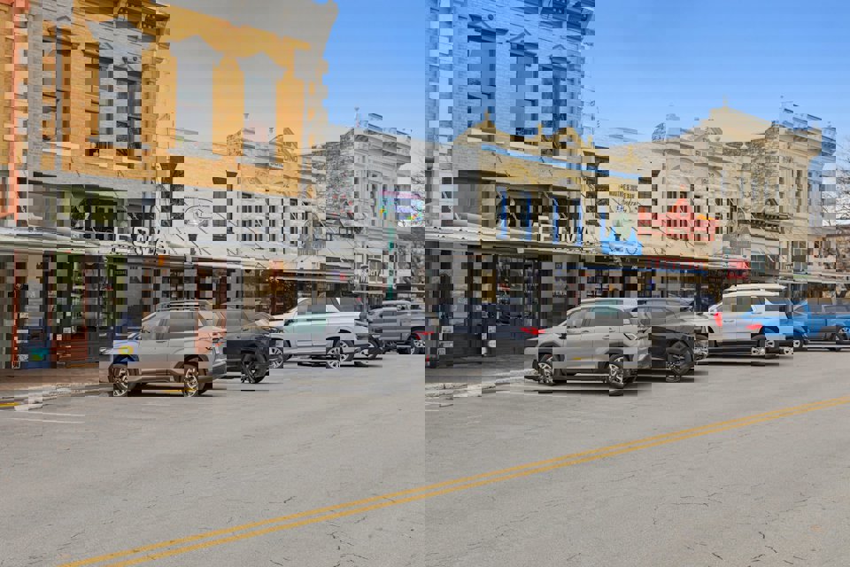 A group of cars parked on the side of a street.