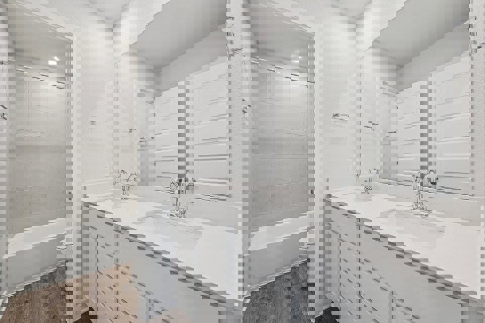 A bathroom with a tub sink and toilet.