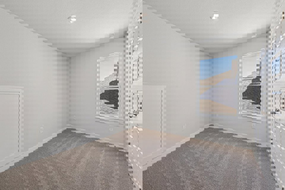 A room with white walls and a painting on the wall.