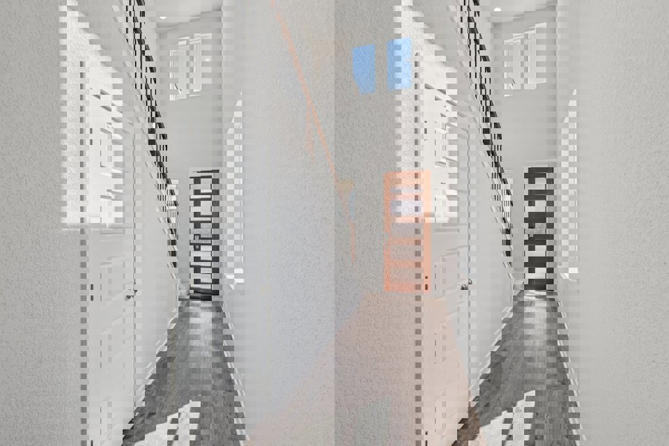 A hallway with white doors.