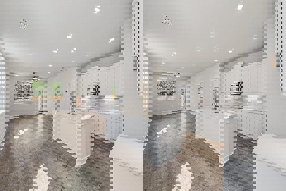 A kitchen with white cabinets.