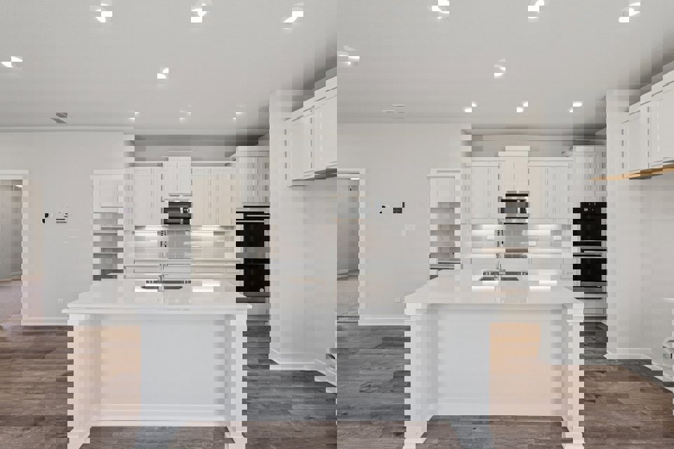 A kitchen with white cabinets.