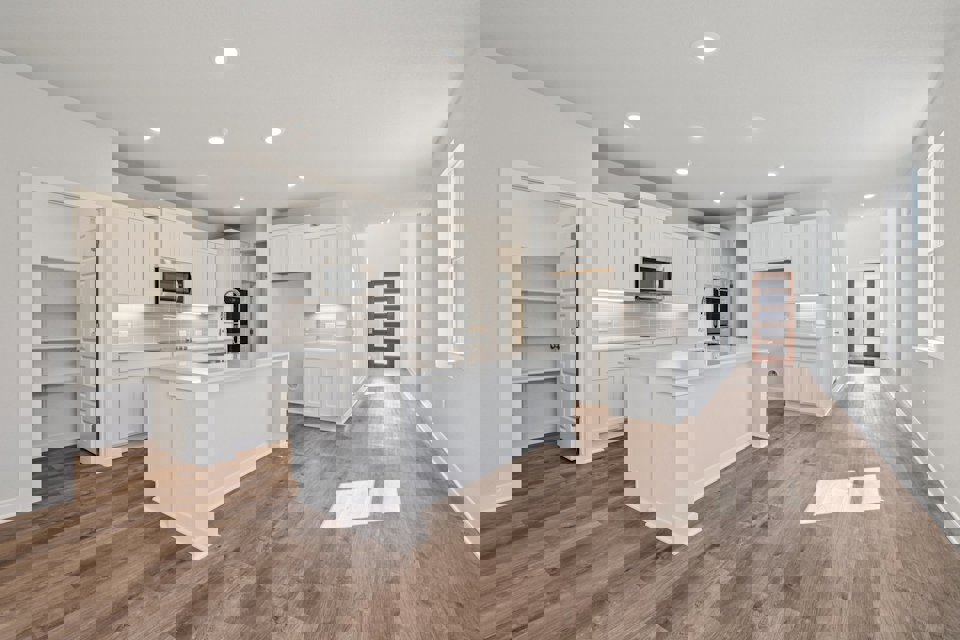 A kitchen with white cabinets.