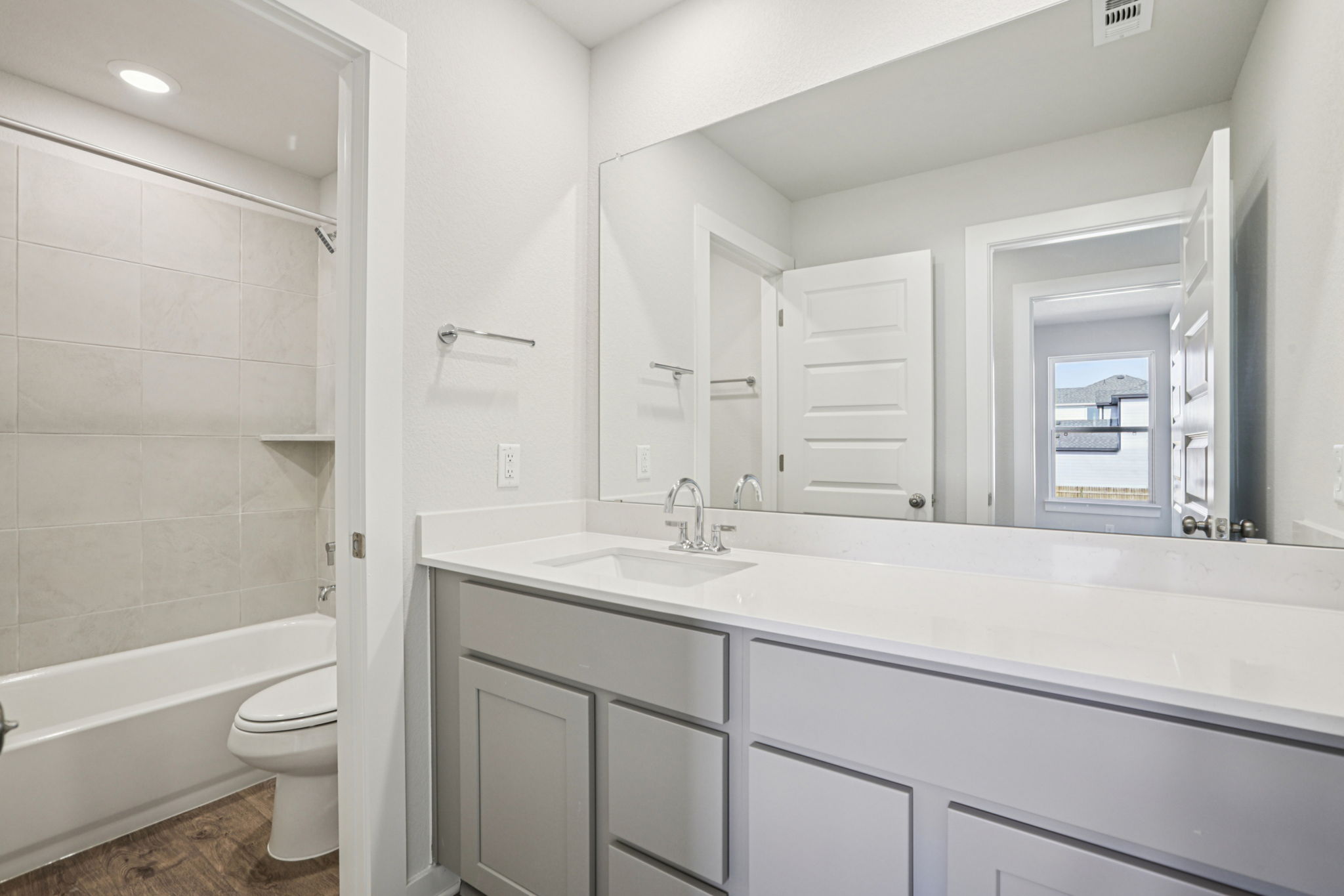 A bathroom with a tub sink and toilet.