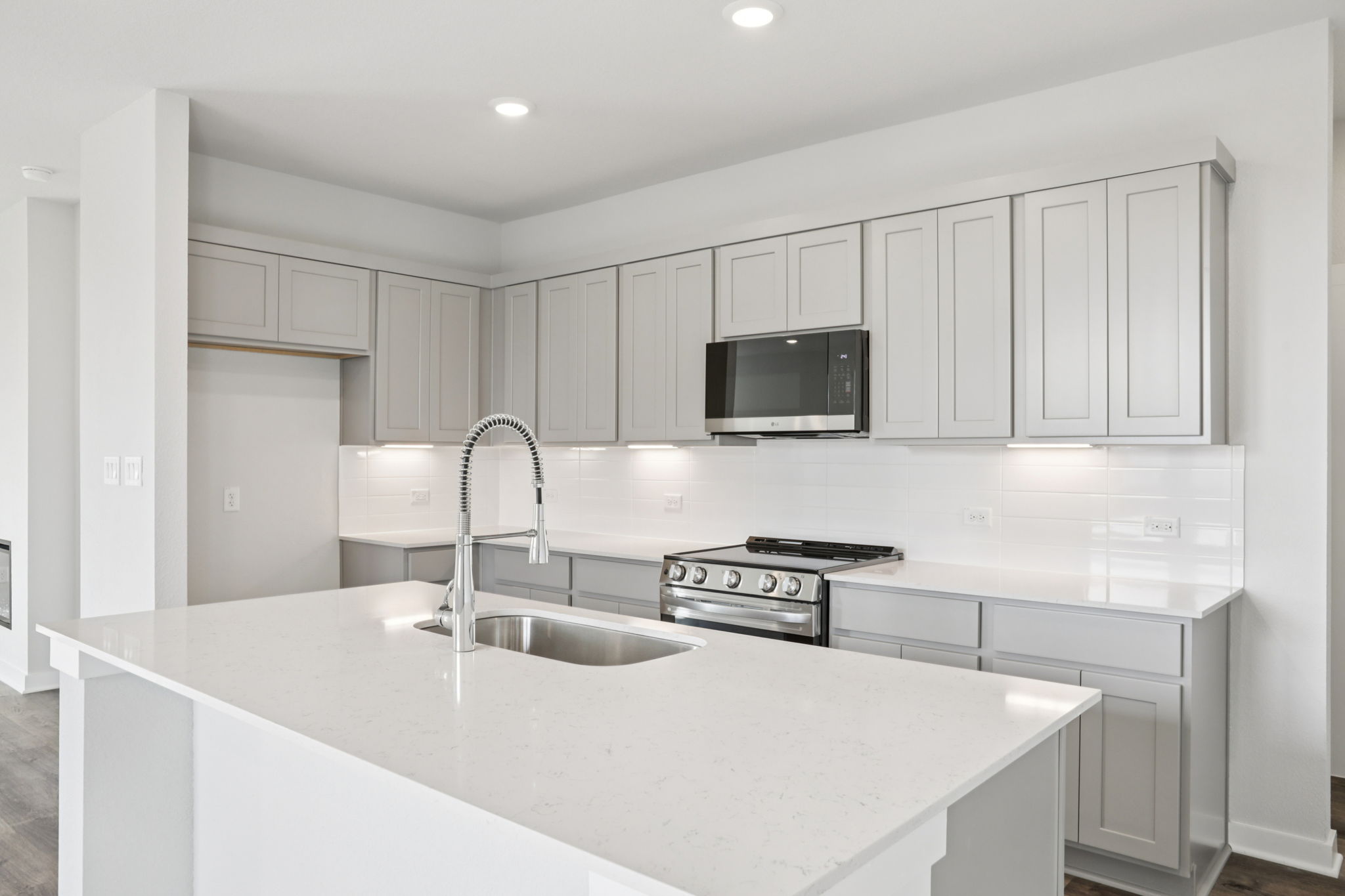 A kitchen with white cabinets.