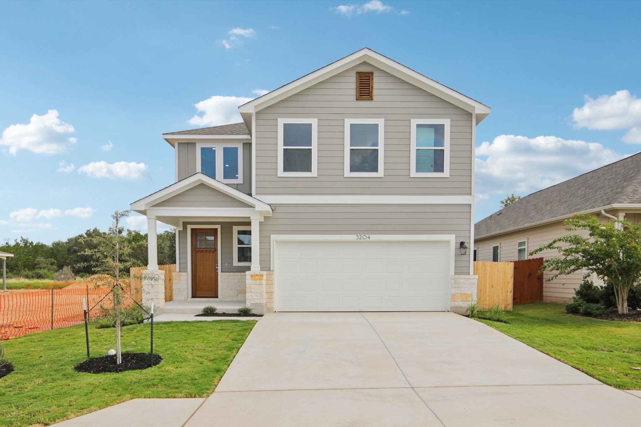 A white house with a driveway.