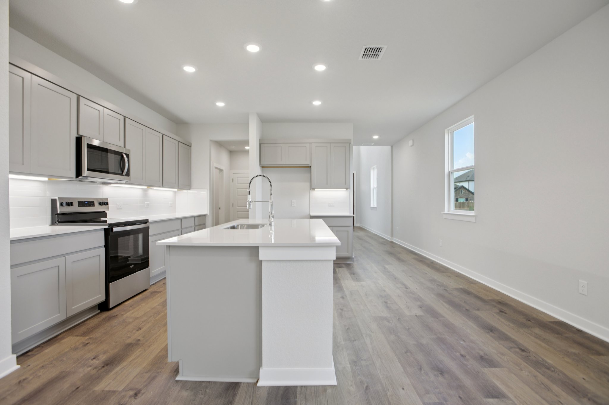 A kitchen with white cabinets.