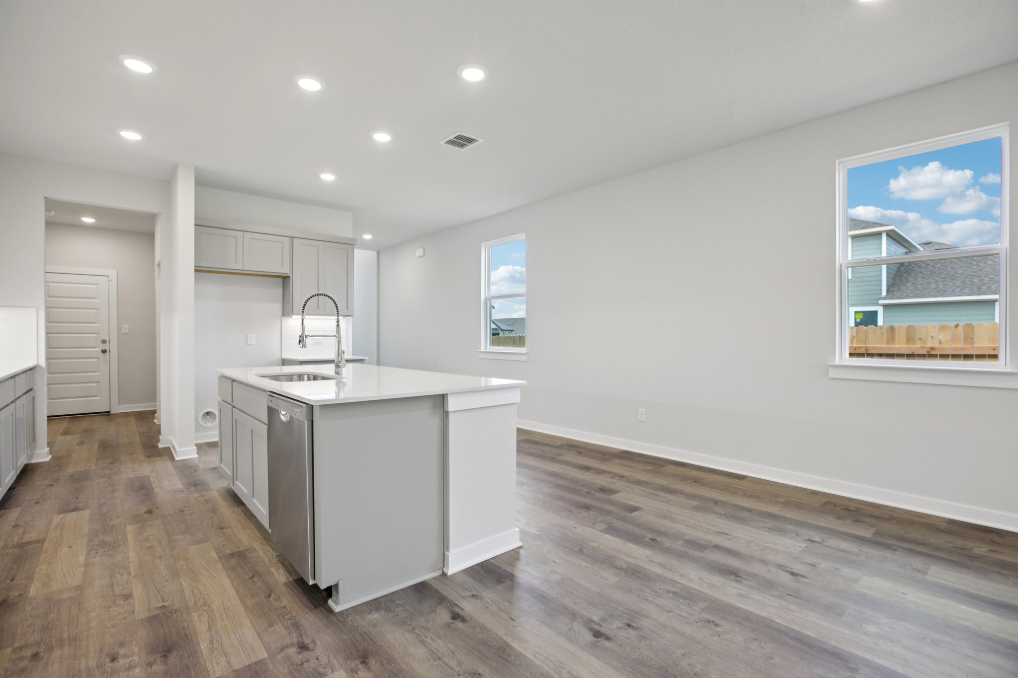 A kitchen with white cabinets.