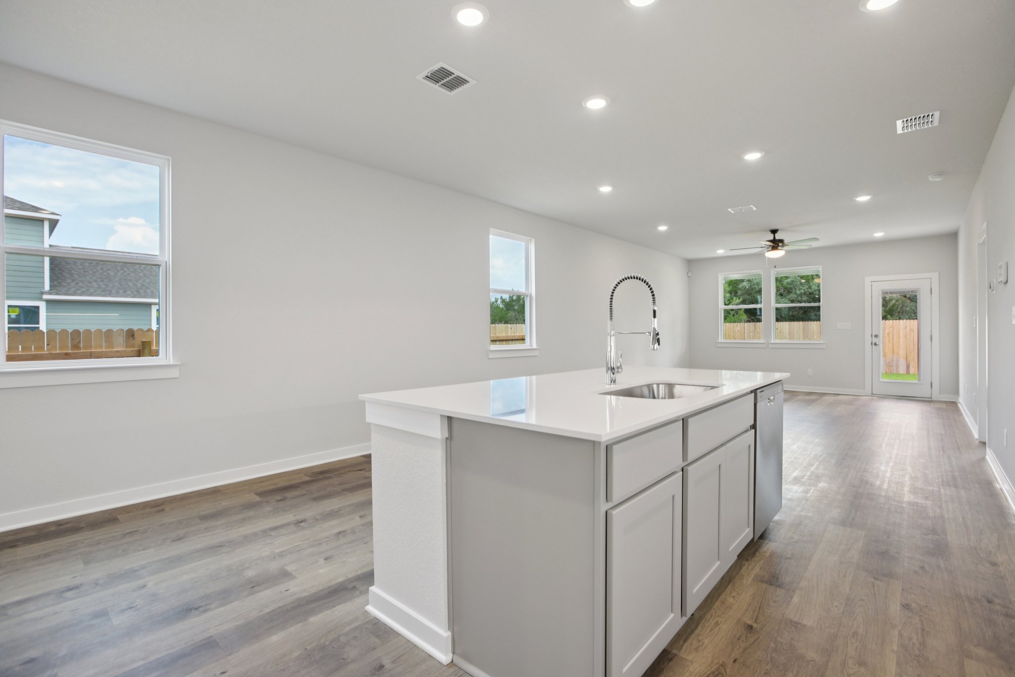 A kitchen with white cabinets.