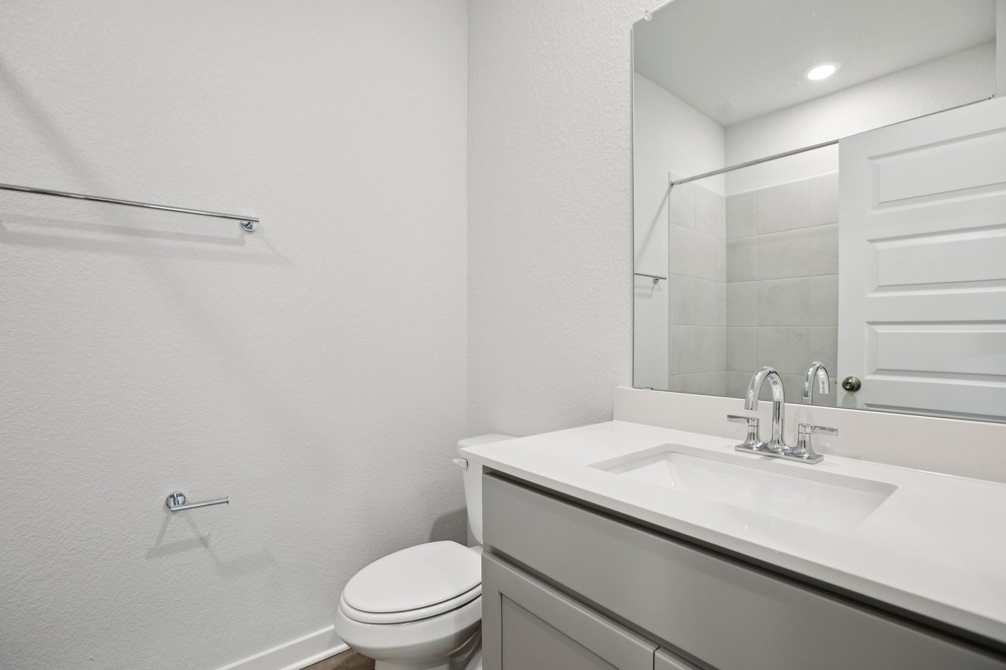 A bathroom with a sink and a toilet.