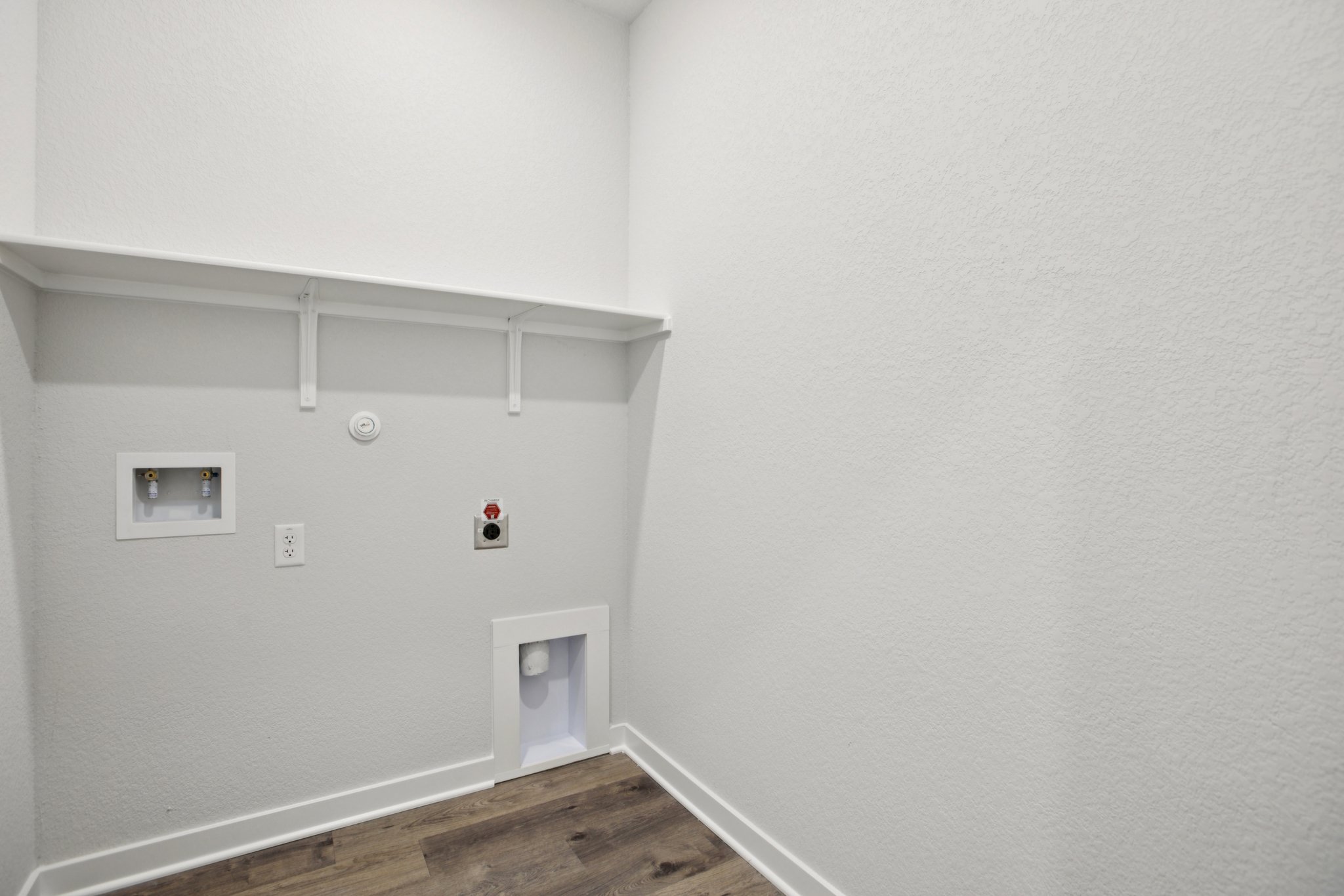 A white wall with a light on it.