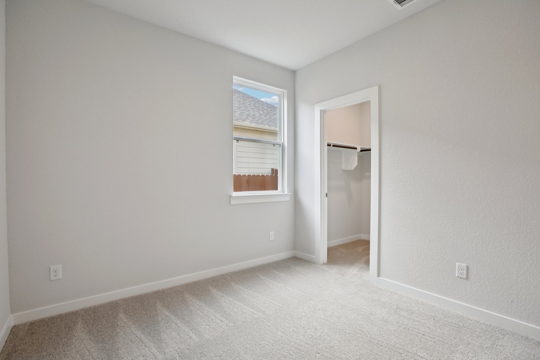 A room with a window and a door.