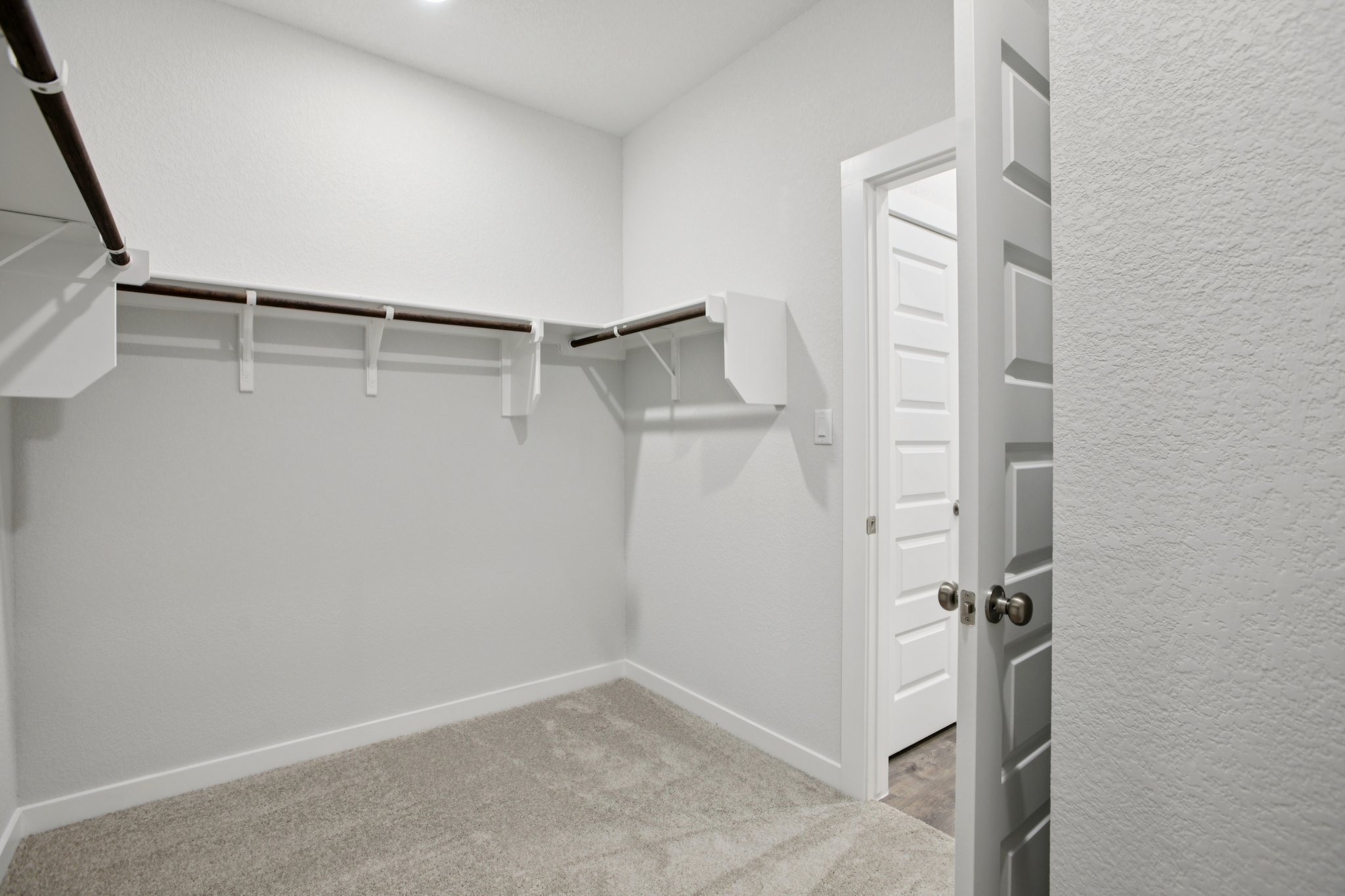 A hallway with white doors.