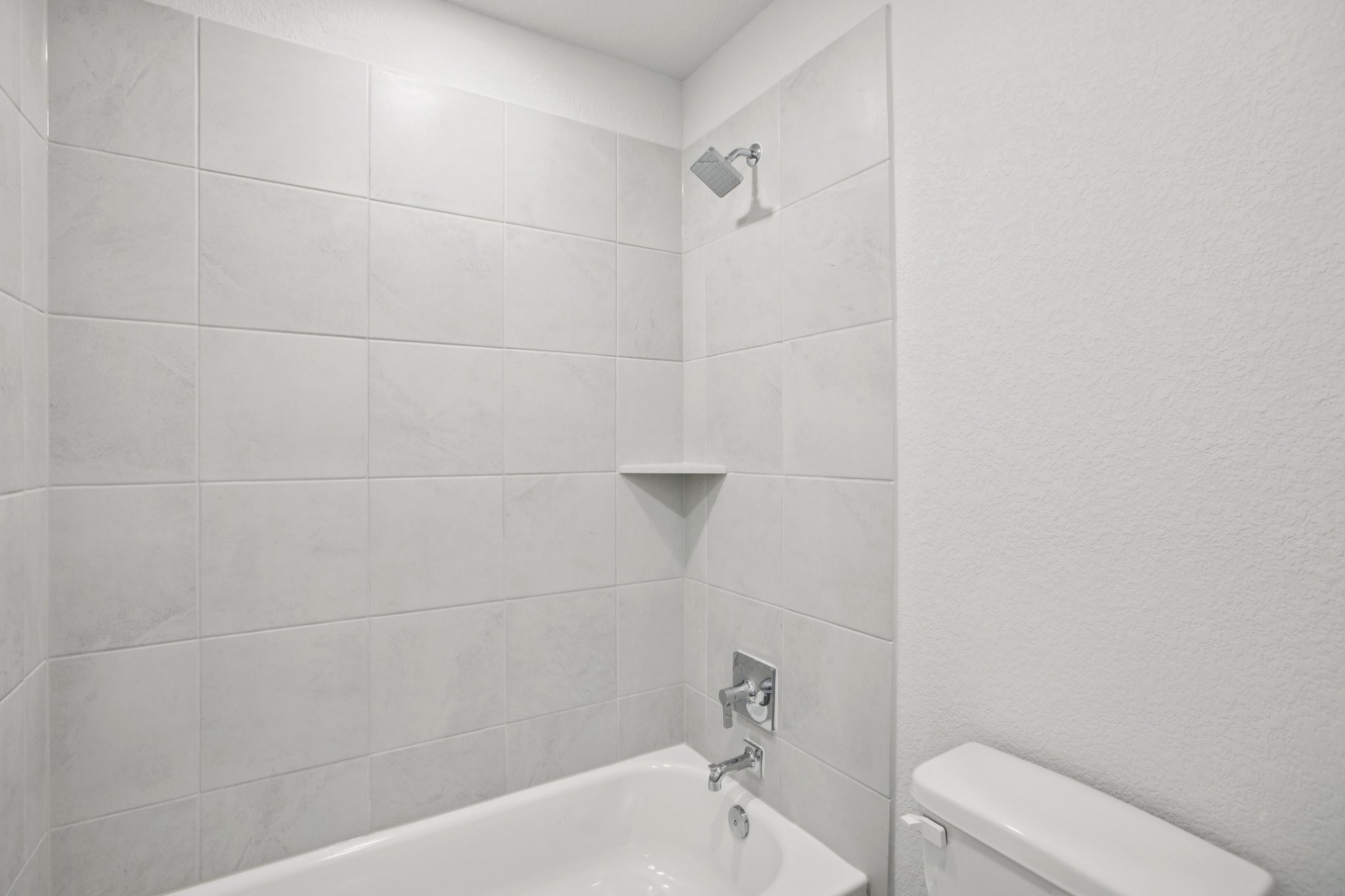 A bathroom with a bathtub and toilet.