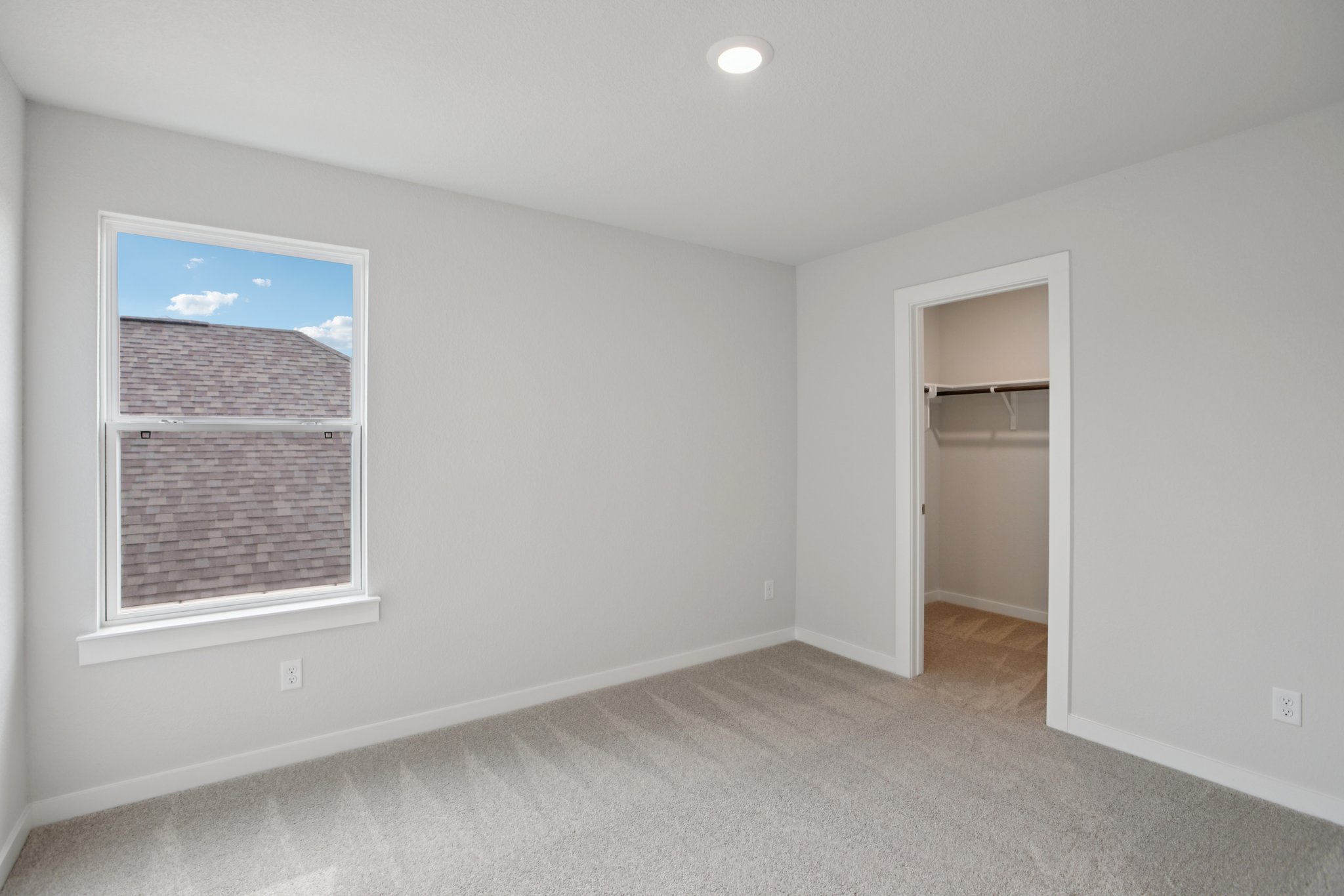 A room with a window and a door.