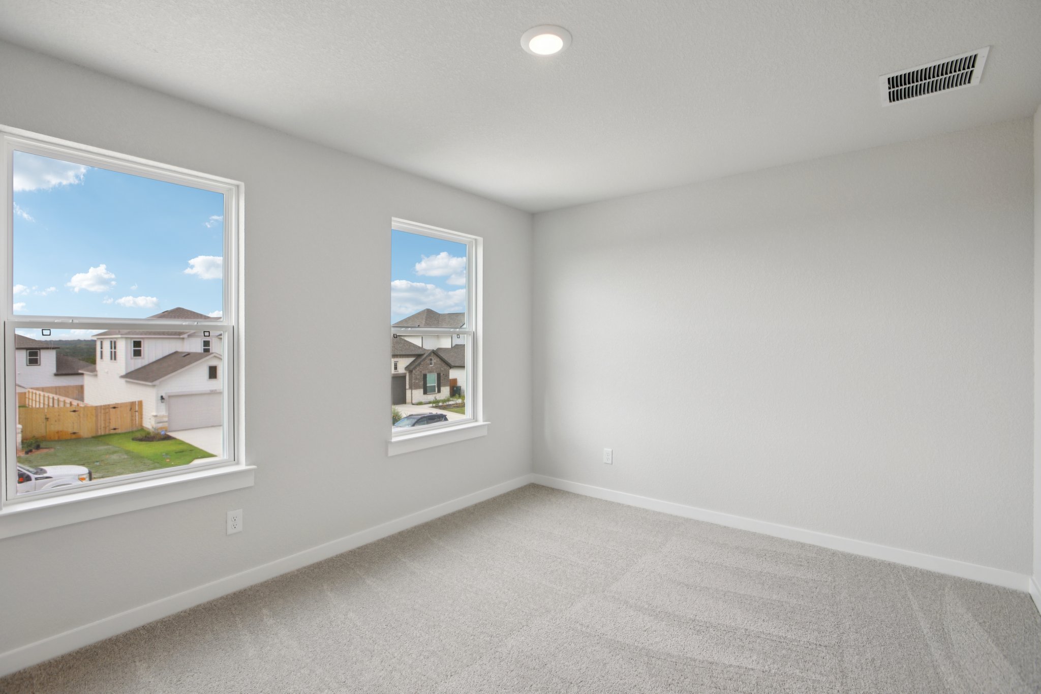 A room with a window and a painting on the wall.