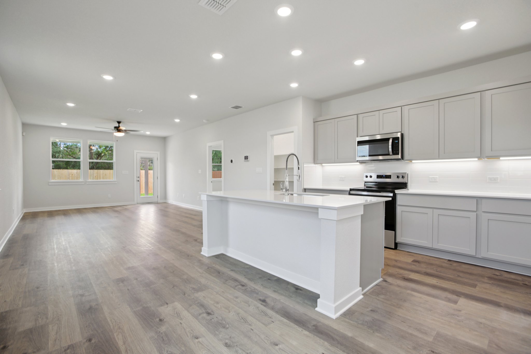 A kitchen with white cabinets.