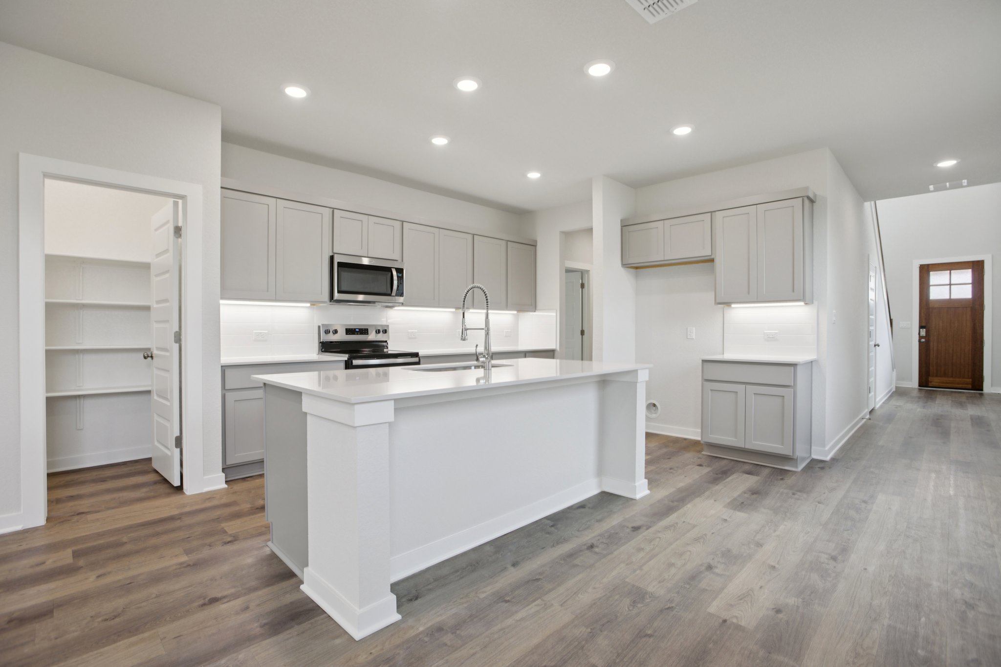 A kitchen with white cabinets.