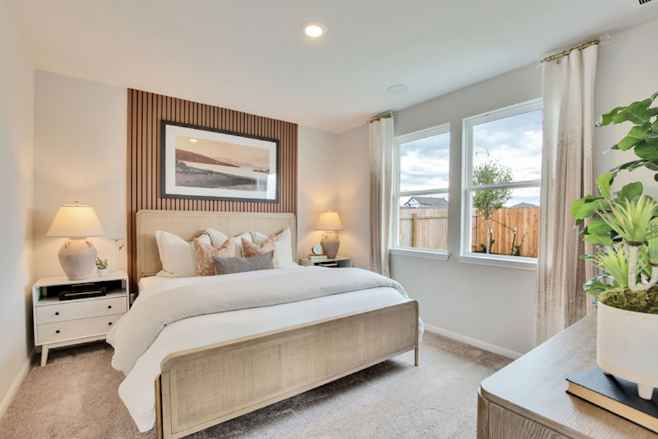 A bedroom with a large window.