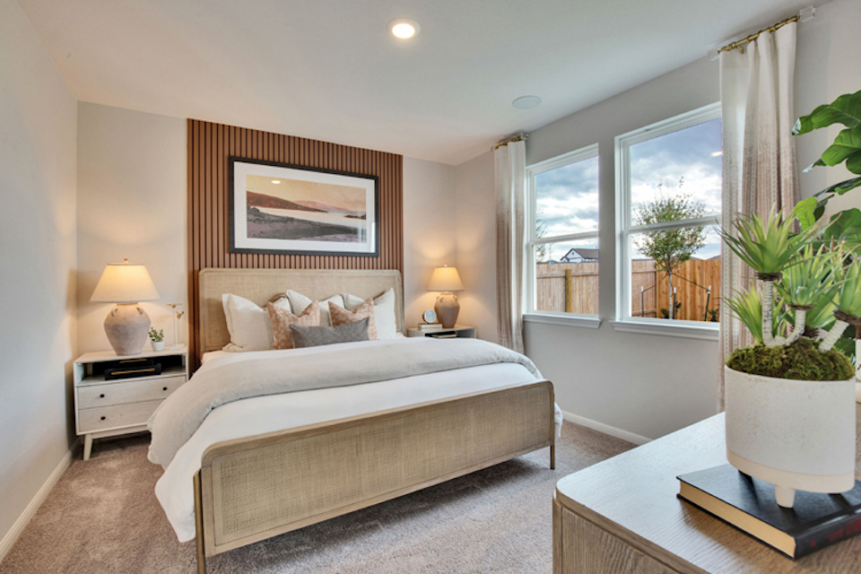 A bedroom with a large window.