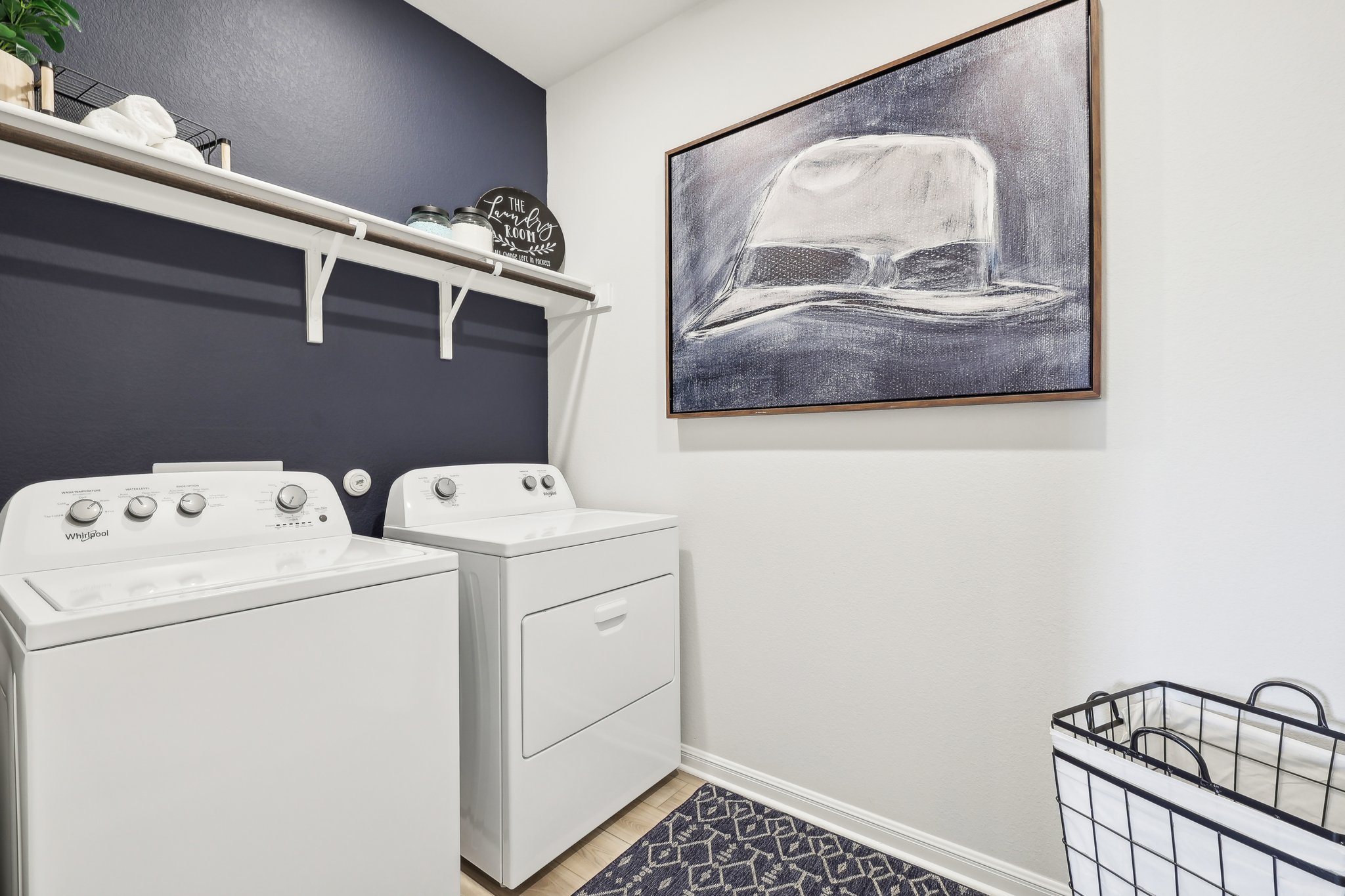 A laundry room with a shelf and a radiator.