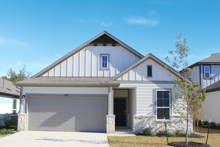 A house with a garage with American Gothic House in the background.