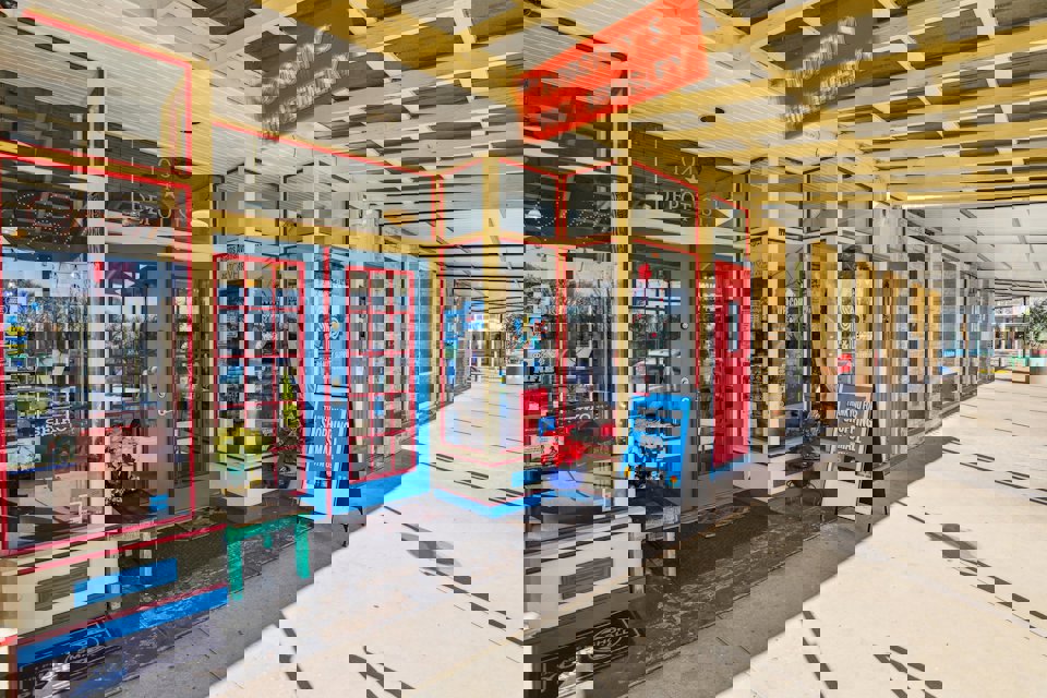 A store front with red doors.