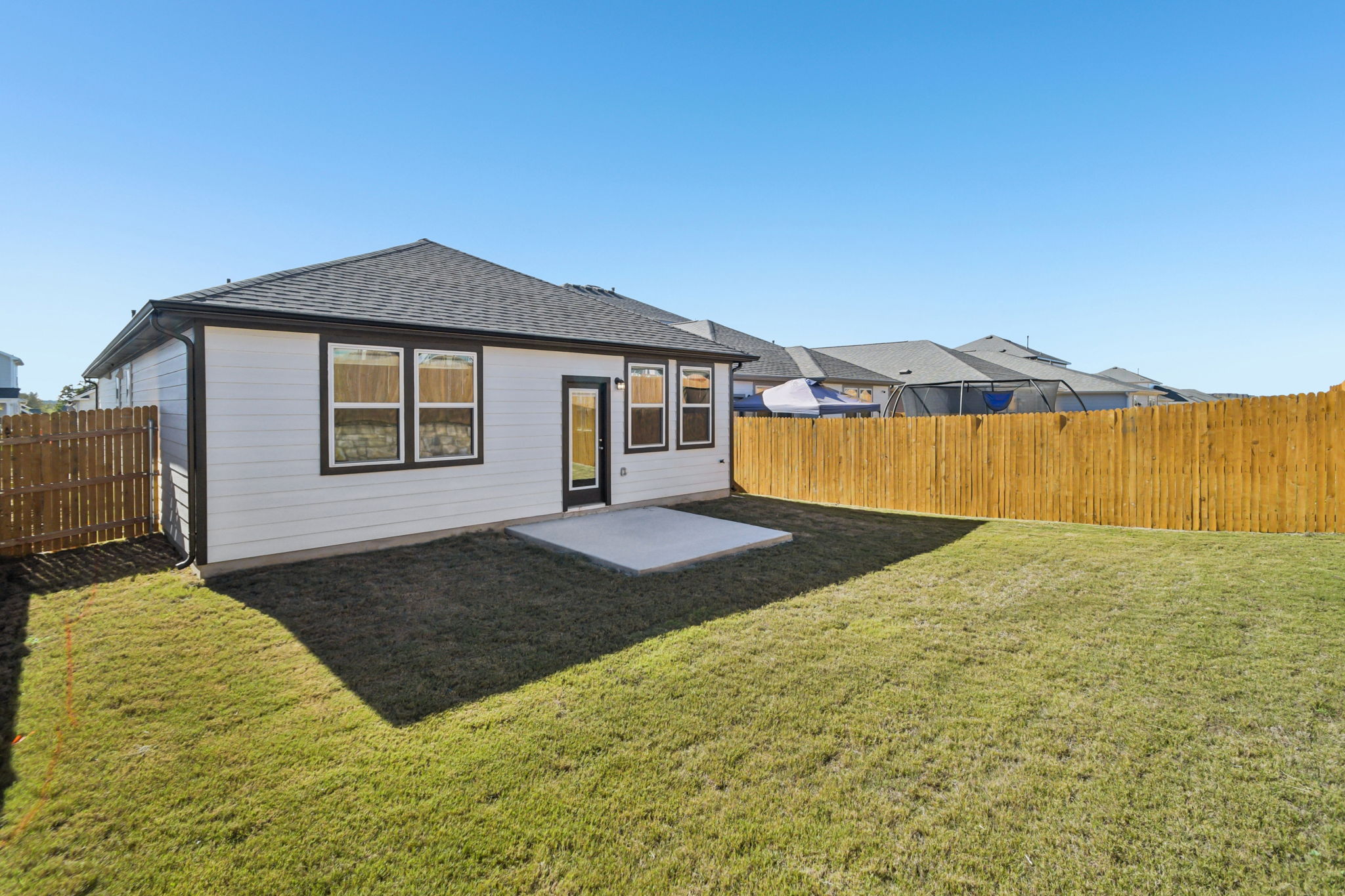 A small house with a fence.