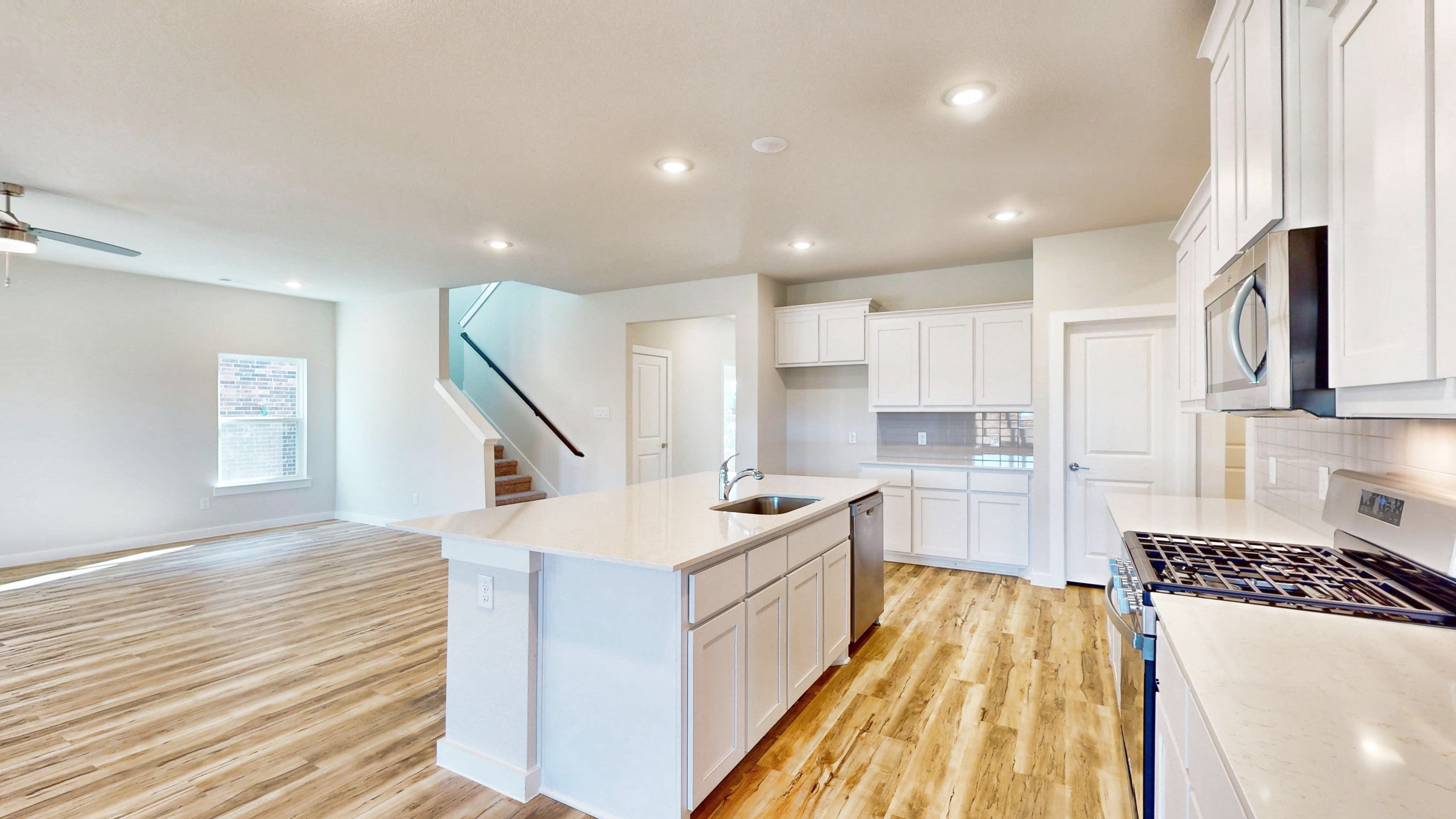 A kitchen with white cabinets.