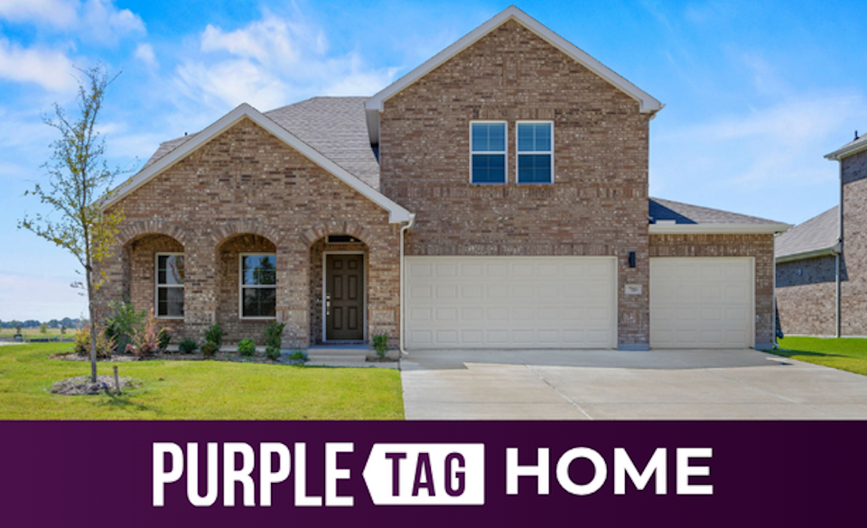 A brick house with a driveway.