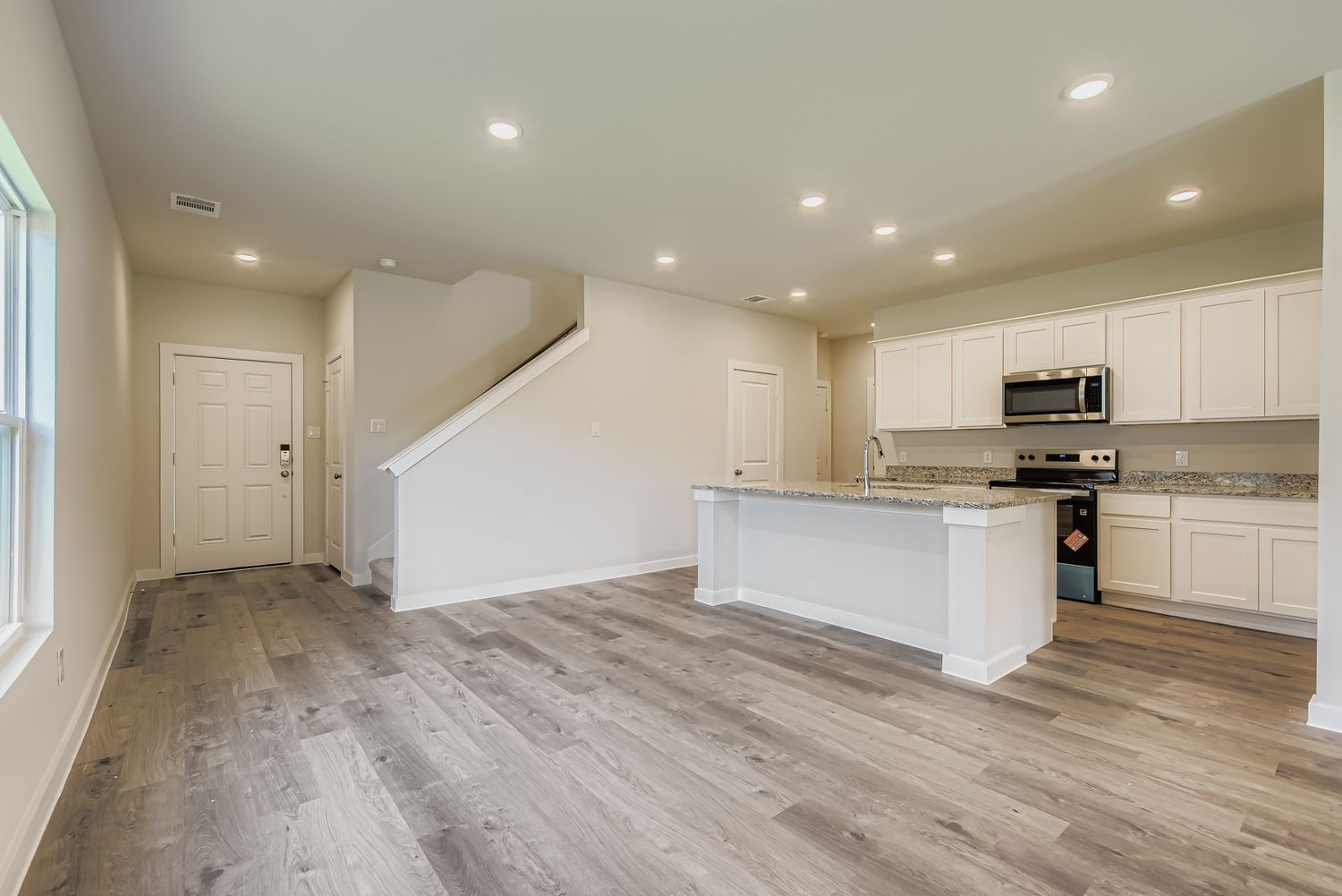 A kitchen with white cabinets.