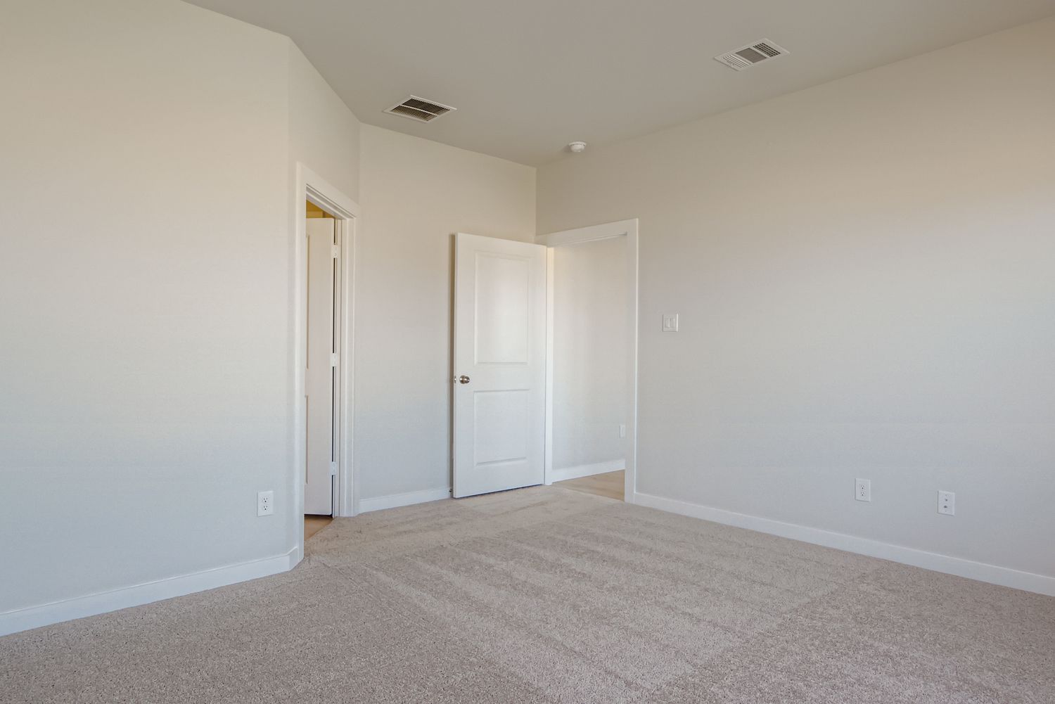 A hallway with white doors.