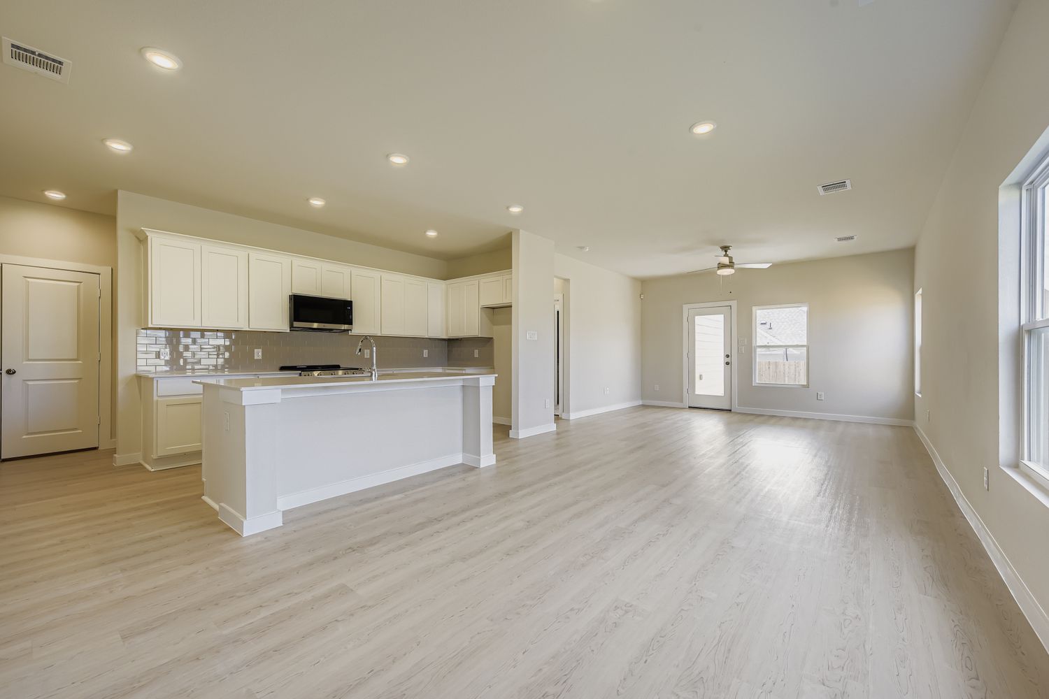 A large kitchen with white cabinets.